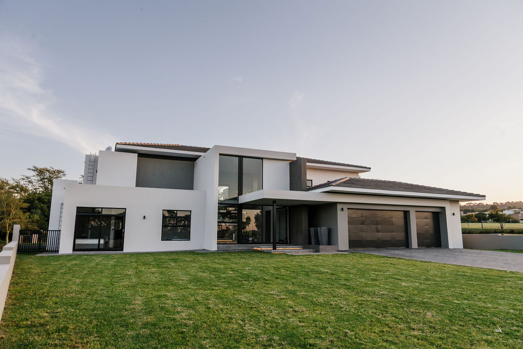 Exterior view of House Phalale — contemporary family home positioned beside a pond in Lombardy Estate, Pretoria, designed by Aloe Studio Architects